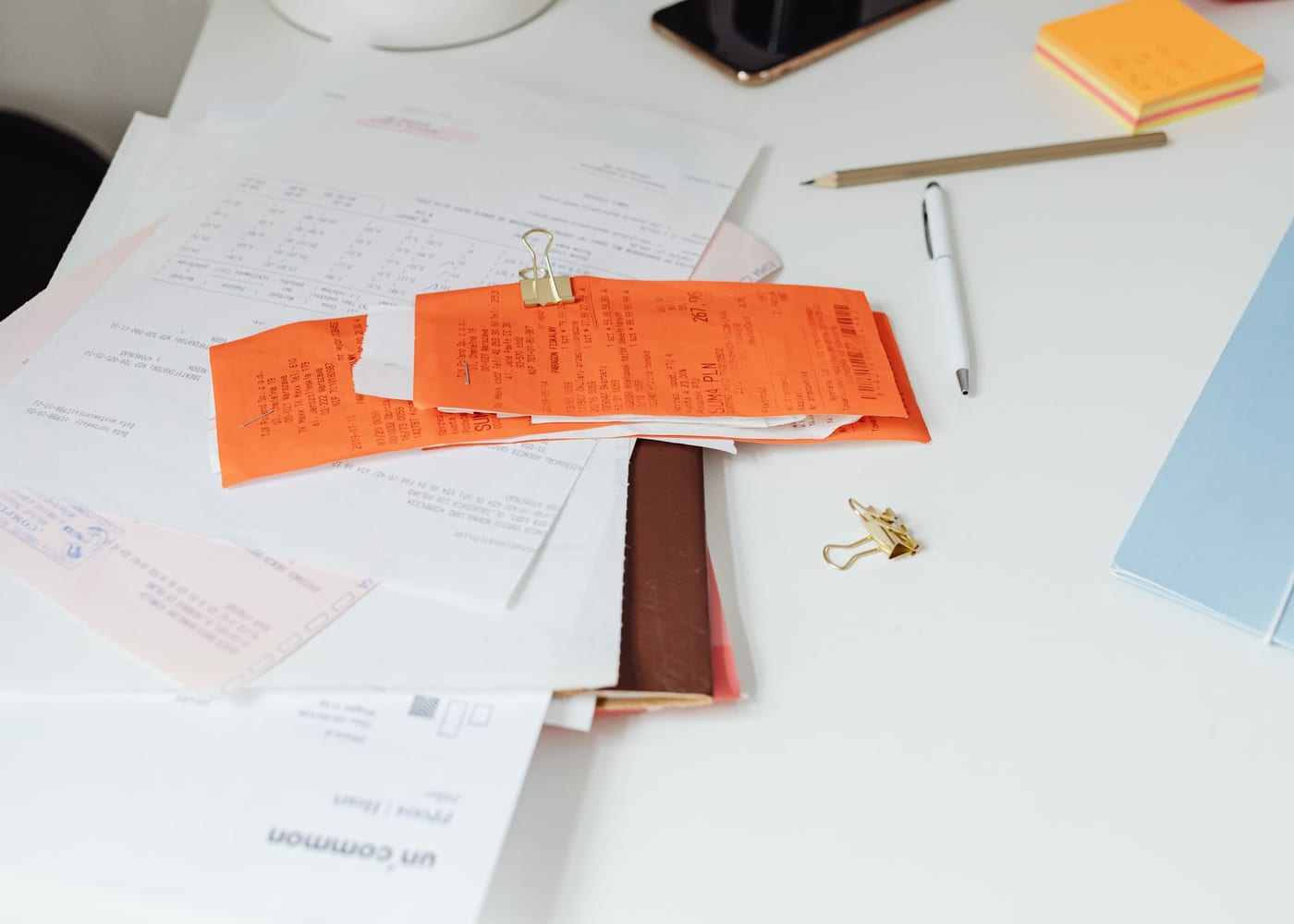 Business paperwork, receipts and documents laid out on a desk